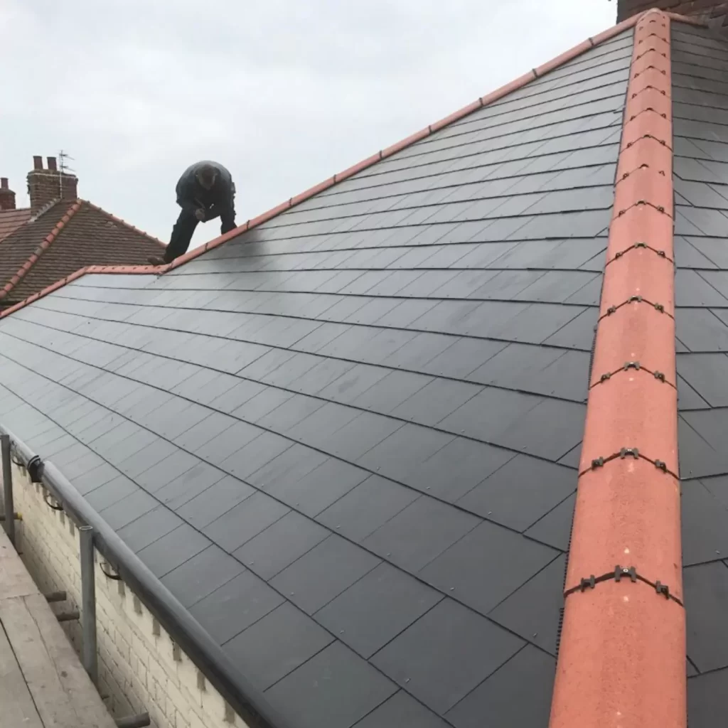 a man repairing a brand new tiled roof